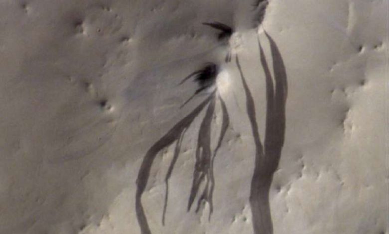 Камера CaSSIS на борту ExoMars Trace Gas Orbiter ЕКА запечатлела темные пальцеобразные полосы склона, простирающиеся по пыльной поверхности Марса в Arabia Terra.